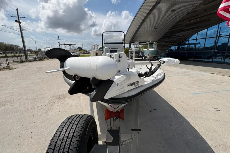 Slide: The Image of 2020 Blazer Bay 2170 boat with Minn Kota motor on trailer, outdoor setting. - 9