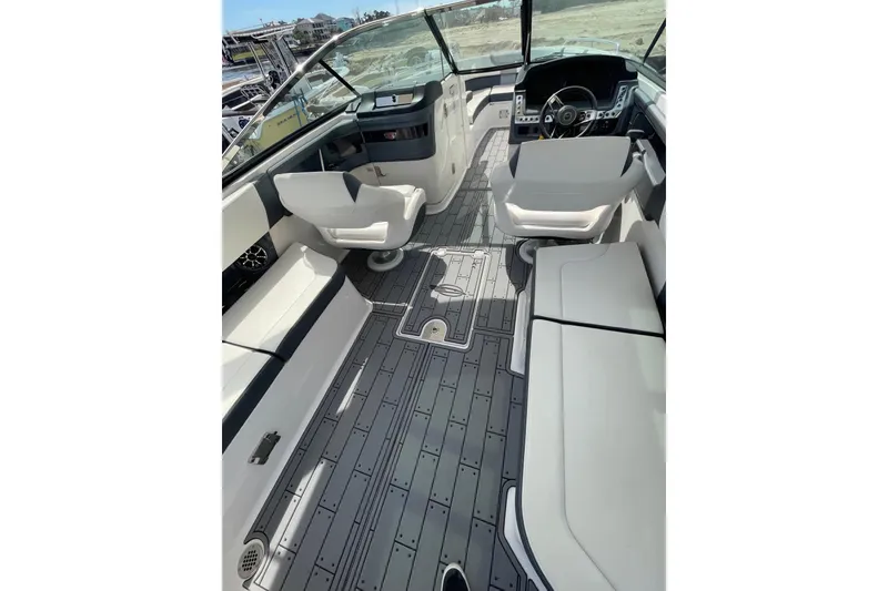 Slide: The Image of 2019 Chaparral 297 SSX boat interior with modern seating and sleek dashboard design. - 12