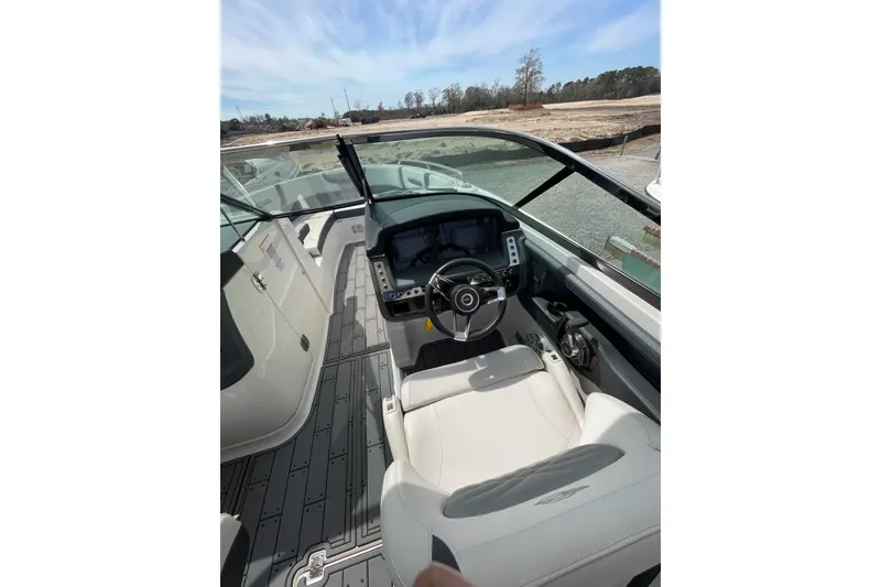 Slide: The Image of 2019 Chaparral 297 SSX boat interior with steering wheel and dashboard view. - 13