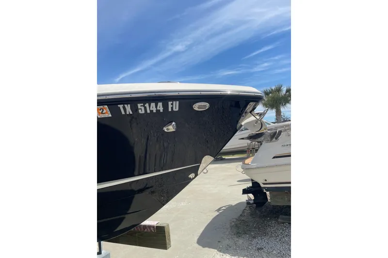 Slide: The Image of 2019 Chaparral 297 SSX boat with registration TX 5144 FU, parked outdoors. - 17