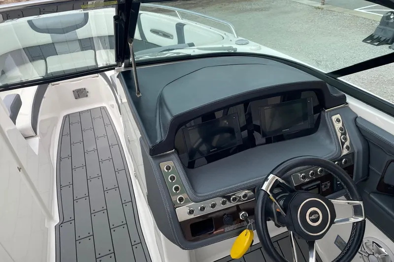 Slide: The Image of 2019 Chaparral 297 SSX boat dashboard with steering wheel and control panels. - 19