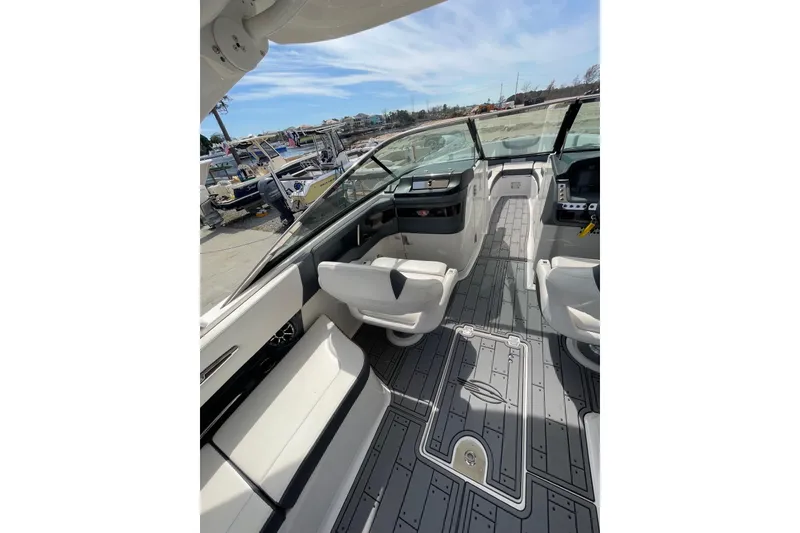 Slide: The Image of 2019 Chaparral 297 SSX boat interior with modern seating and dashboard. - 20