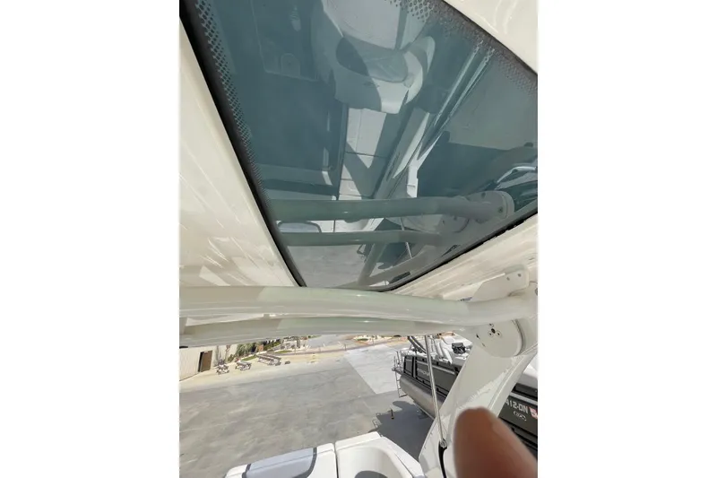 Slide: The Image of 2019 Chaparral 297 SSX boat with a sleek glass roof and sturdy frame. - 24