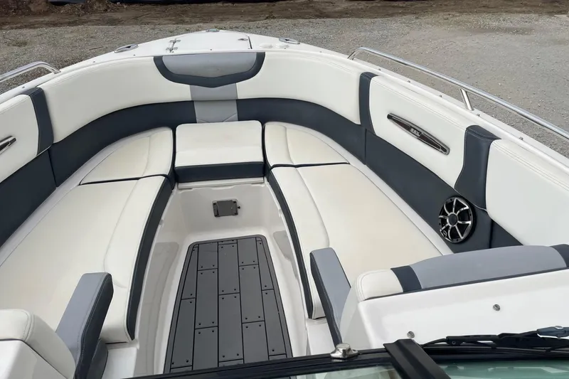 Slide: The Image of 2019 Chaparral 297 SSX boat interior with white and gray seating, speaker, and deck. - 26