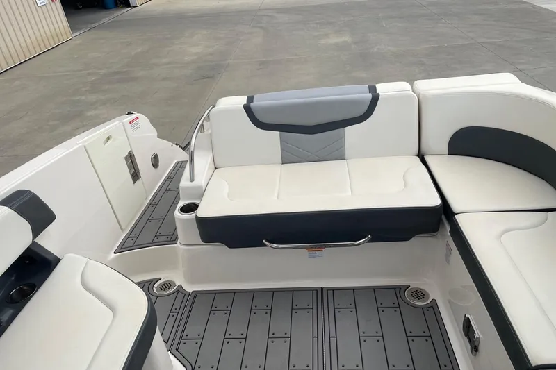 Slide: The Image of 2019 Chaparral 297 SSX boat interior with white and gray seating and flooring. - 28