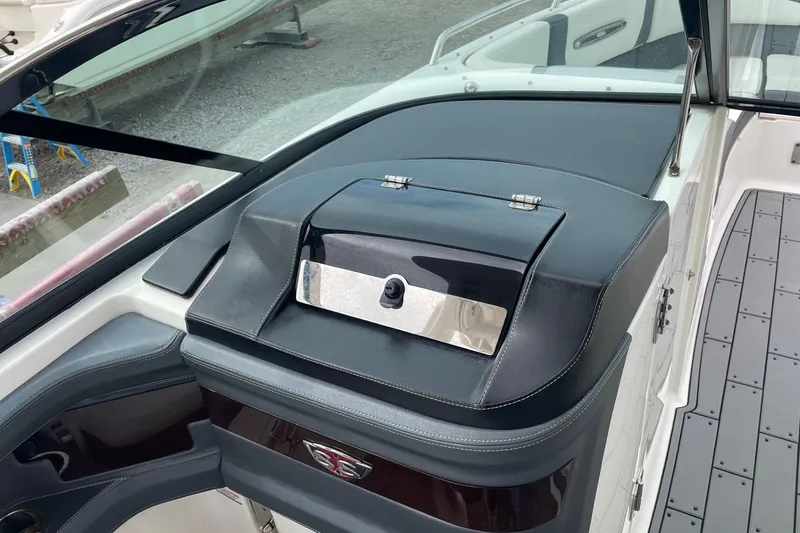 Slide: The Image of 2019 Chaparral 297 SSX boat dashboard with sleek black and chrome accents. - 29