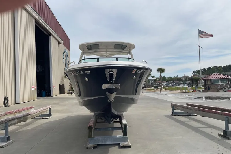 Slide: The Image of 2019 Chaparral 297 SSX boat on trailer near marina and storage facility. - 3