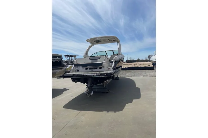 Slide: The Image of 2019 Chaparral 297 SSX boat on trailer under a clear blue sky. - 30