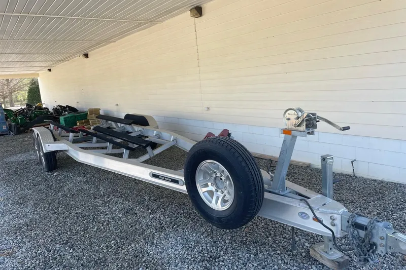 Slide: The Image of Boat trailer parked on gravel under a covered area, suitable for 2019 Chaparral 297 SSX. - 34