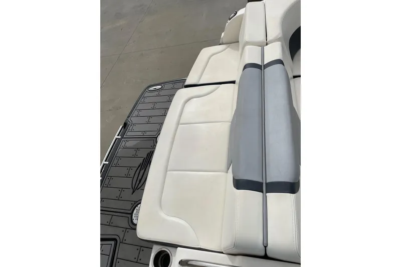 Slide: The Image of 2019 Chaparral 297 SSX boat with white and gray seating on deck. - 35