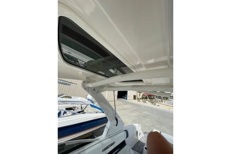 Slide: The Image of 2019 Chaparral 297 SSX boat interior view with sunroof and seating area. - 37