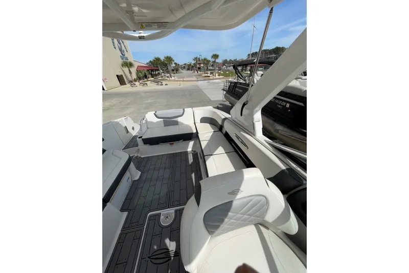 Slide: The Image of 2019 Chaparral 297 SSX boat interior with white seating and sleek design. - 38