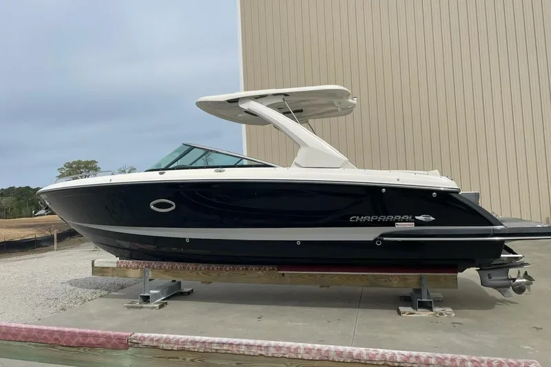 Slide: The Image of 2019 Chaparral 297 SSX boat on display, side view, outdoors. - 43