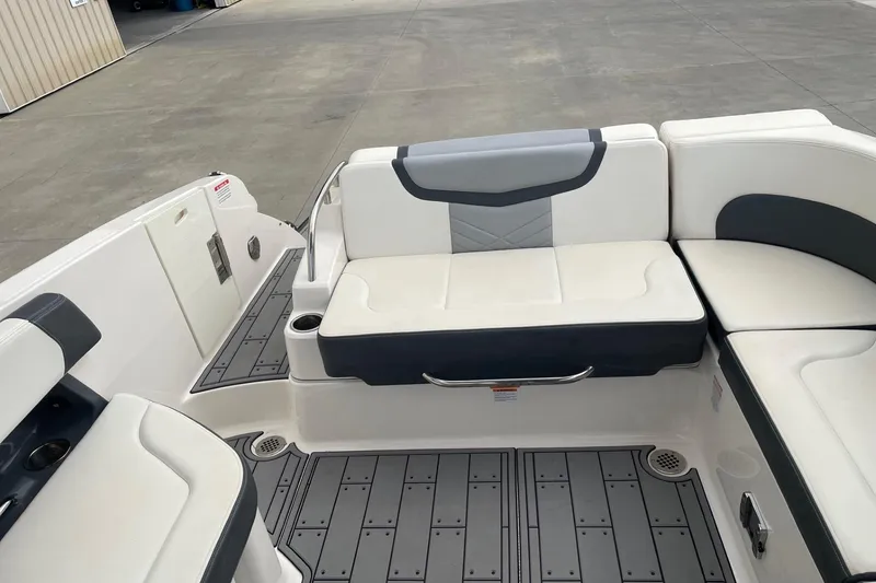 Slide: The Image of 2019 Chaparral 297 SSX boat interior with white and gray seating and flooring. - 44