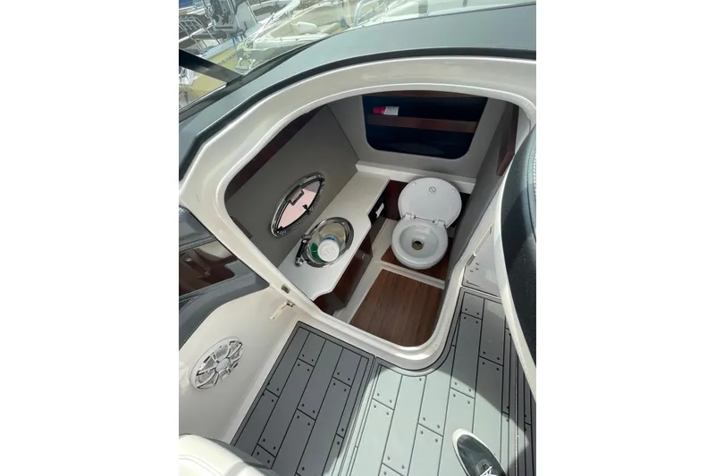 Slide: The Image of 2019 Chaparral 297 SSX boat interior with toilet and porthole view. - 45