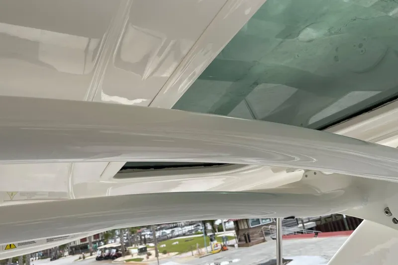 Slide: The Image of 2019 Chaparral 297 SSX boat interior with sleek white design and glass elements. - 47