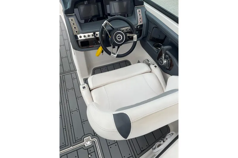 Slide: The Image of 2019 Chaparral 297 SSX boat cockpit with steering wheel and control panel. - 48