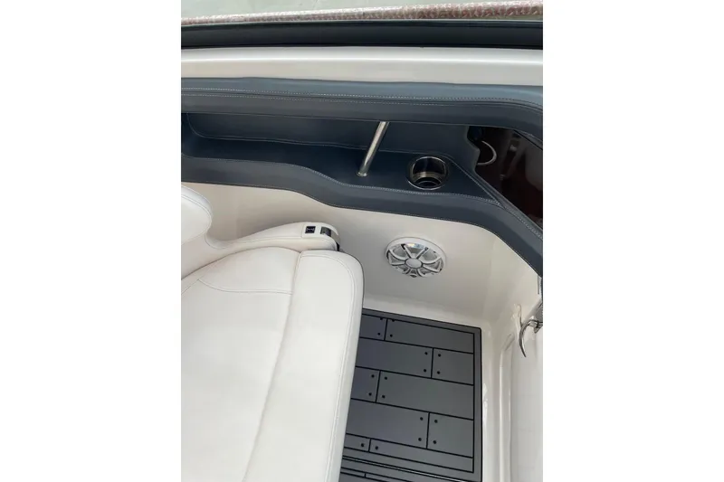 Slide: The Image of 2019 Chaparral 297 SSX interior with white seating, speaker, and cup holder. - 5