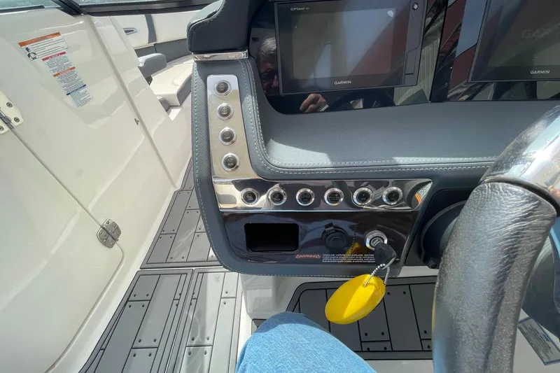 Slide: The Image of 2019 Chaparral 297 SSX boat dashboard with Garmin displays and control panel. - 7