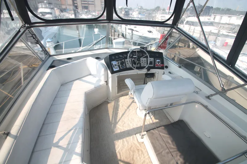 Slide: The Image of 1996 Carver 330 Mariner yacht interior, helm station and seating area. - 10