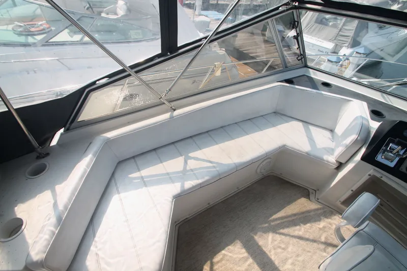 Slide: The Image of Interior of a 1996 Carver 330 Mariner yacht with white seating area. - 12