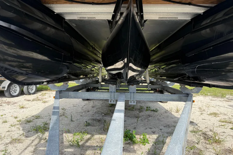 Slide: The Image of Underside view of 2023 Regency 230 DL3 pontoon boat on a trailer. - 10
