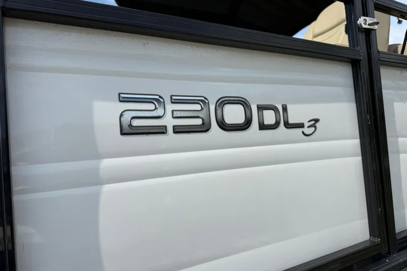 Slide: The Image of 2023 Regency 230 DL3 logo on white boat exterior. - 11