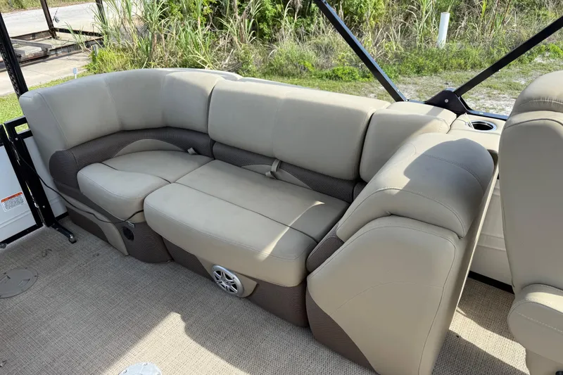 Slide: The Image of Luxurious seating on 2023 Regency 230 DL3 pontoon boat, featuring plush beige upholstery. - 18