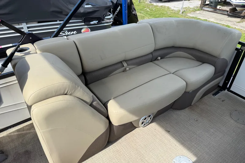 Slide: The Image of 2023 Regency 230 DL3 boat interior with beige cushioned seating. - 19