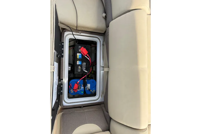 Slide: The Image of Battery compartment of 2023 Regency 230 DL3 boat, under seat storage. - 24