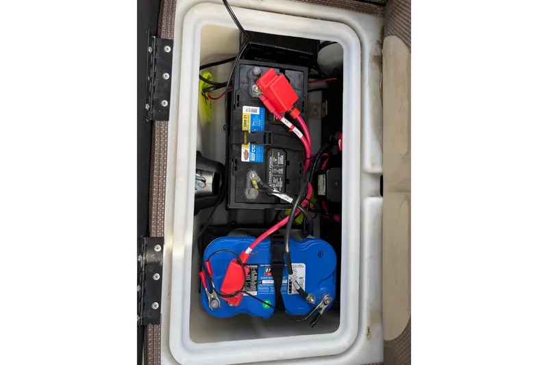 Slide: The Image of Battery compartment of 2023 Regency 230 DL3 with wiring and connections visible. - 25