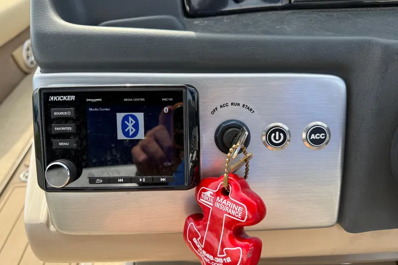 Slide: The Image of Dashboard of 2023 Regency 230 DL3 with Kicker media center and ignition key. - 36