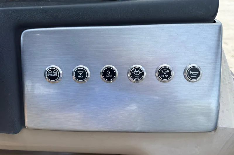 Slide: The Image of Control panel of 2023 Regency 230 DL3 boat with labeled buttons for various functions. - 37