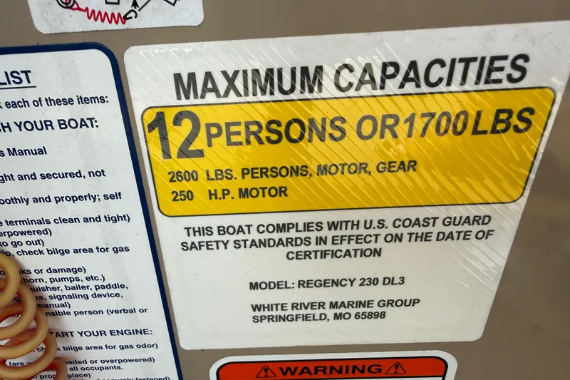 Slide: The Image of 2023 Regency 230 DL3 boat capacity label: 12 persons or 1700 lbs, 250 HP motor. - 39