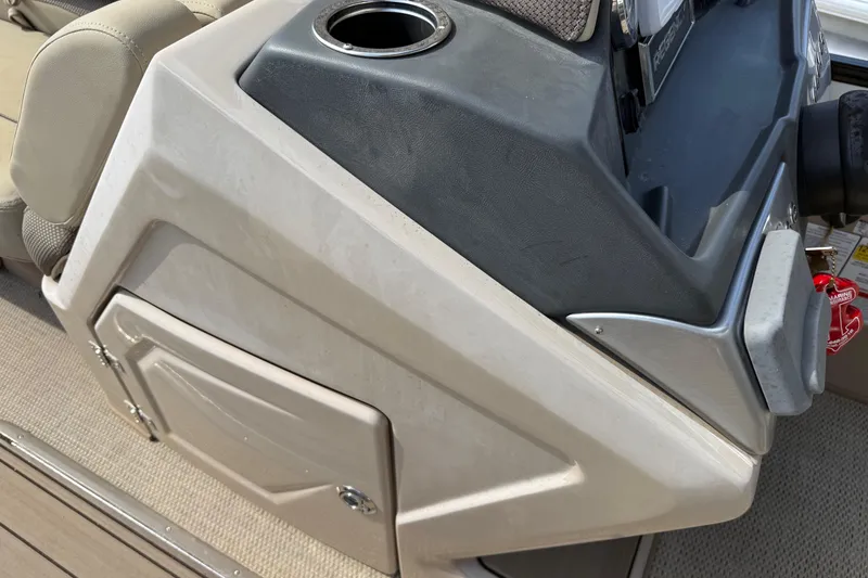 Slide: The Image of 2023 Regency 230 DL3 boat console with cup holder and storage compartment. - 42