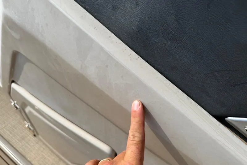 Slide: The Image of Finger pointing at the interior detail of a 2023 Regency 230 DL3 boat. - 43
