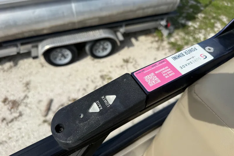 Slide: The Image of Close-up of a 2023 Regency 230 DL3 power bimini control with raise and lower buttons. - 44