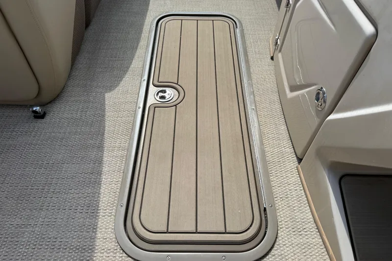 Slide: The Image of 2023 Regency 230 DL3 boat deck with wood finish and storage compartment. - 46