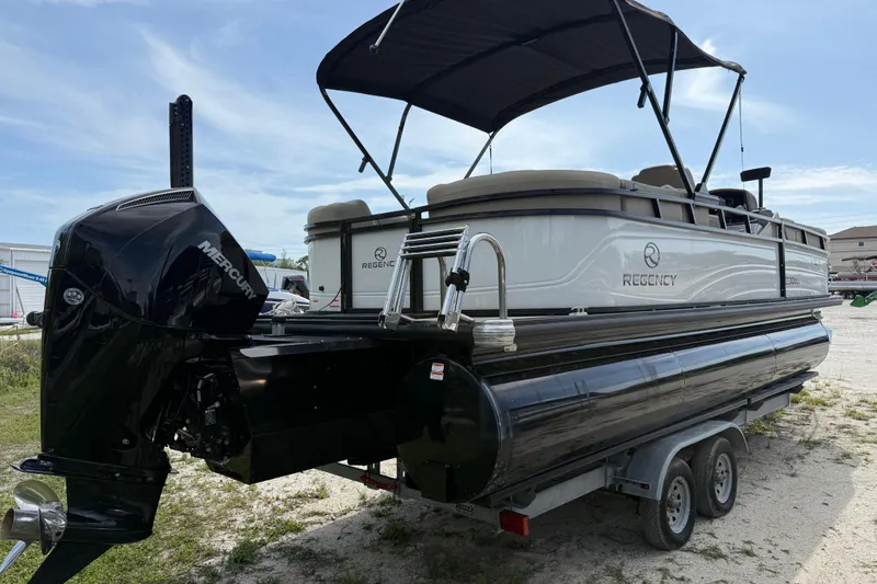 Slide: The Image of 2023 Regency 230 DL3 pontoon boat on trailer with Mercury outboard motor. - 5