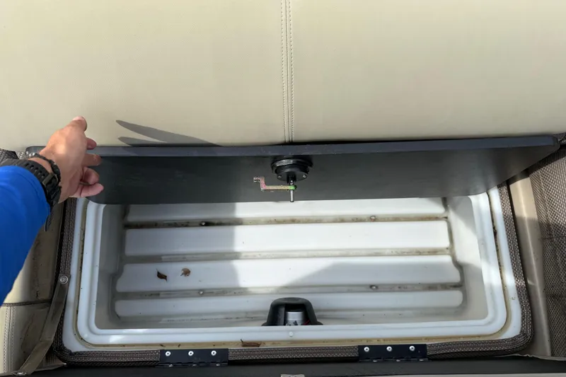 Slide: The Image of Storage compartment in 2023 Regency 230 DL3 boat with open seat lid. - 52