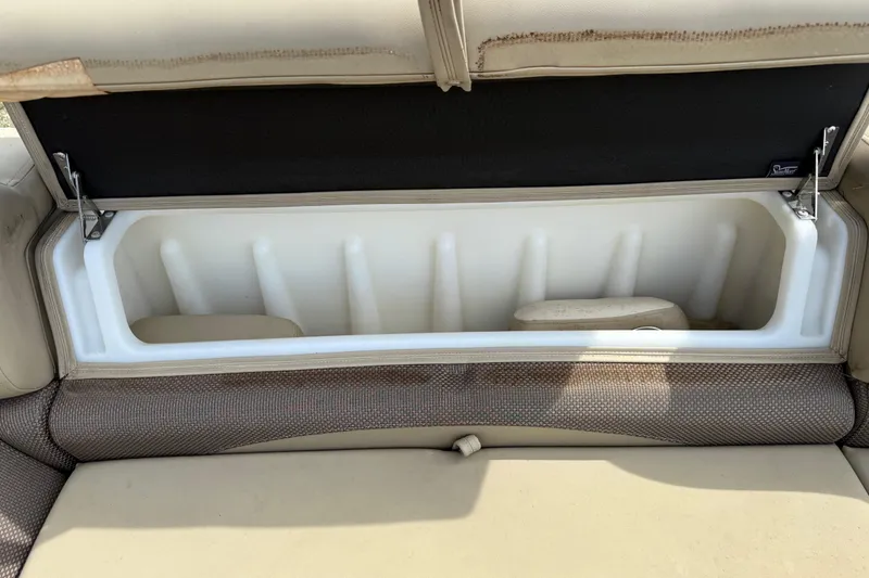 Slide: The Image of Open storage compartment in 2023 Regency 230 DL3 boat seat. - 54