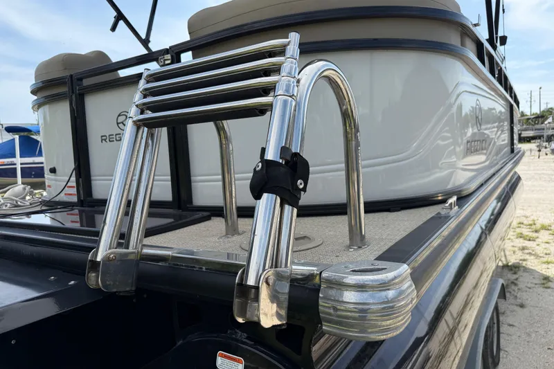 Slide: The Image of 2023 Regency 230 DL3 boat with stainless steel ladder and sleek design. - 6