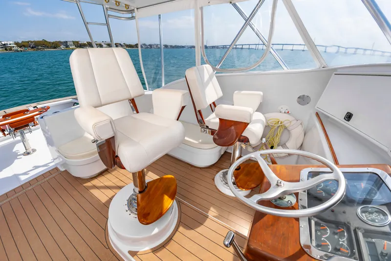 Slide: The Image of Interior of a 1999 Custom Lohr 43 Express yacht with elegant seating. - 12