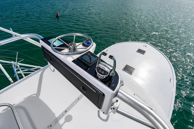 Slide: The Image of Helm of Custom Lohr 43 Express yacht, 1999 model, on open water. - 25