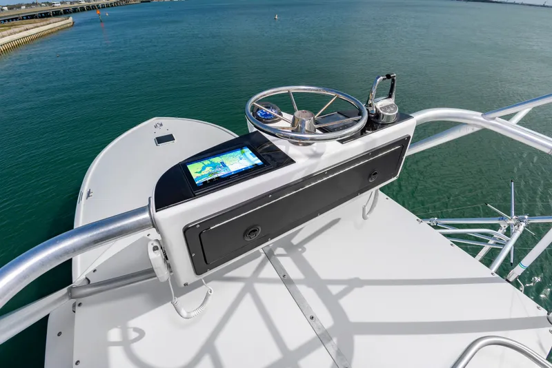 Slide: The Image of Helm of Custom Lohr 43 Express yacht, 1999 model, on open water. - 26