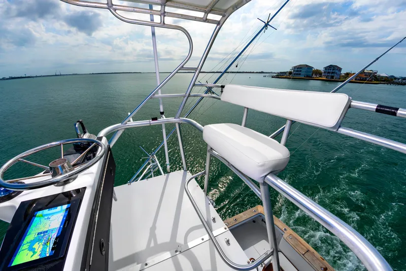 Slide: The Image of Cockpit of Custom Lohr 43 Express yacht, 1999 model, on open water. - 28