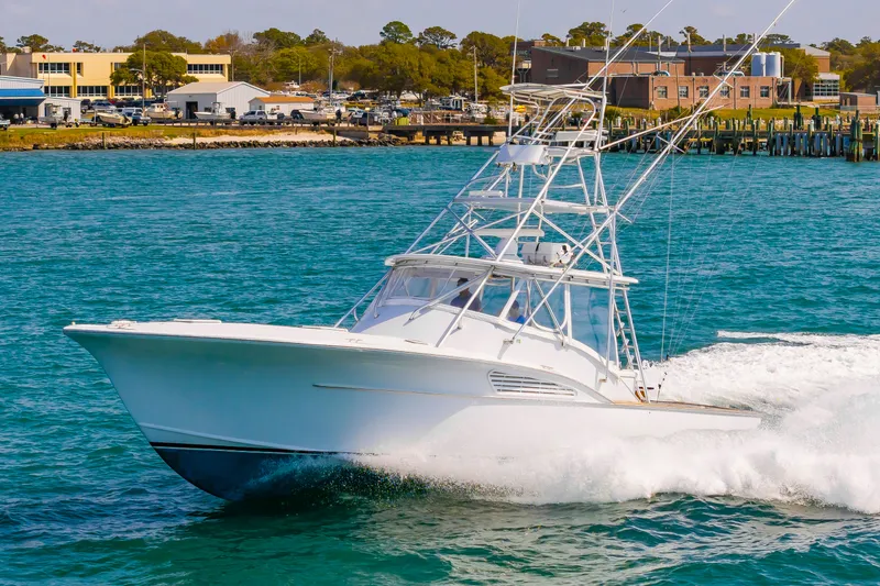 Slide: The Image of Custom Lohr 43 Express 1999 cruising on water, coastal background. - 5