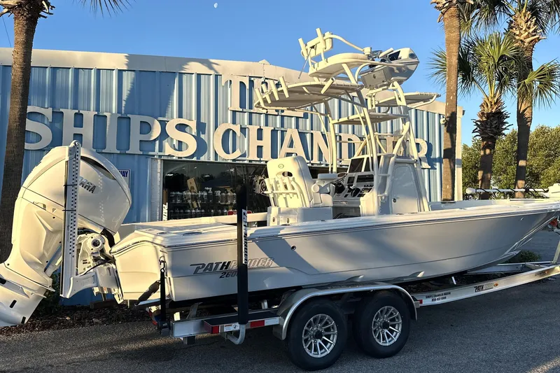 The Image of 2026 Pathfinder 2600 TRS boat on trailer outside marine store. - 0