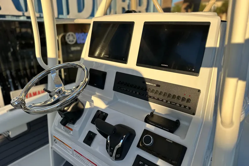 Slide: The Image of 2026 Pathfinder 2600 TRS boat dashboard with dual Garmin displays and steering wheel. - 10