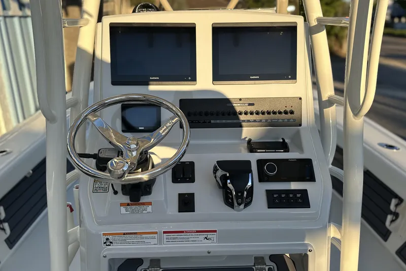 Slide: The Image of 2026 Pathfinder 2600 TRS boat console with dual Garmin displays and steering wheel. - 11